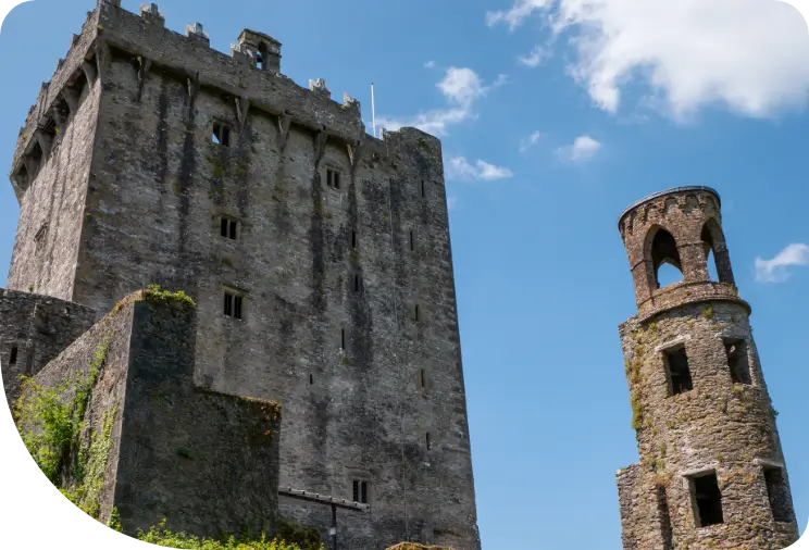 Ancient castle with a round tower against a blue sky.