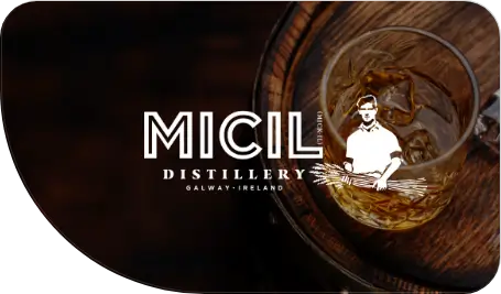 Micil logo over image of whiskey